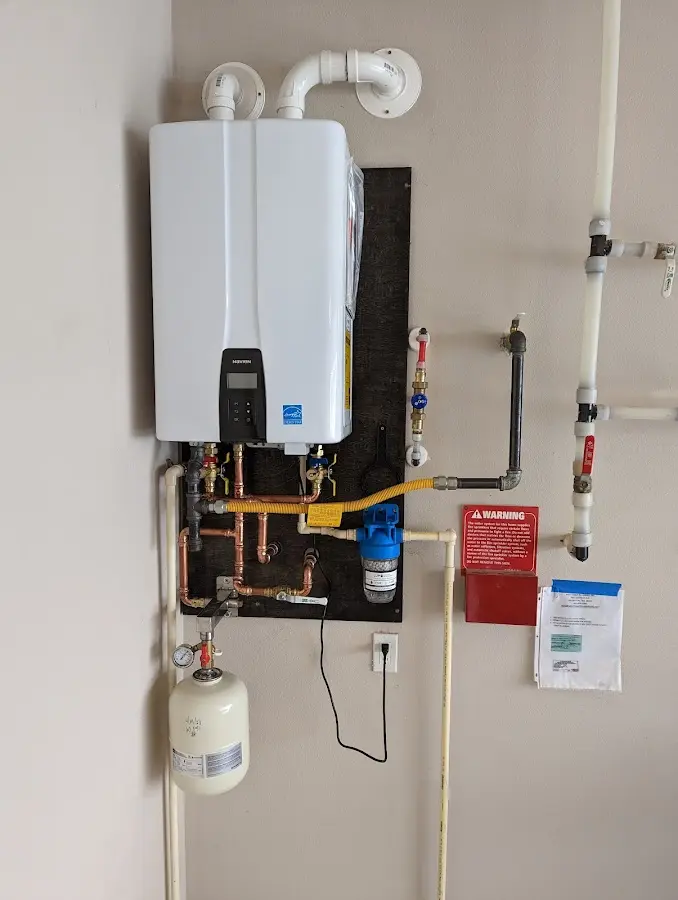 Professional plumber installing copper piping in a Bethel home